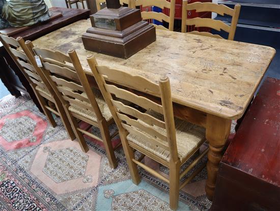 A pine kitchen table and six beech ladderback rush seated chairs W.183cm